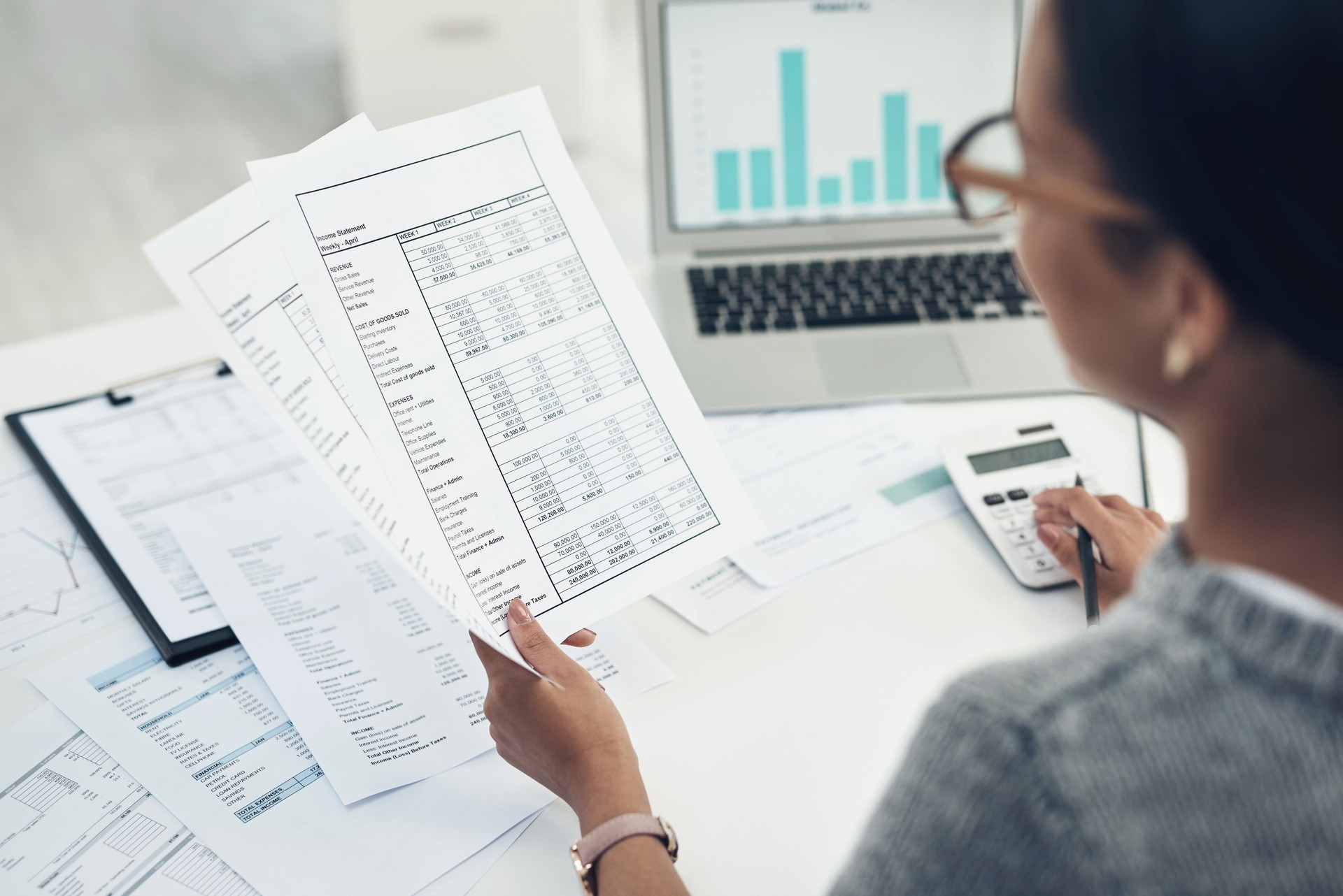 Closeup shot of an unrecognisable businesswoman calculating finances in an office