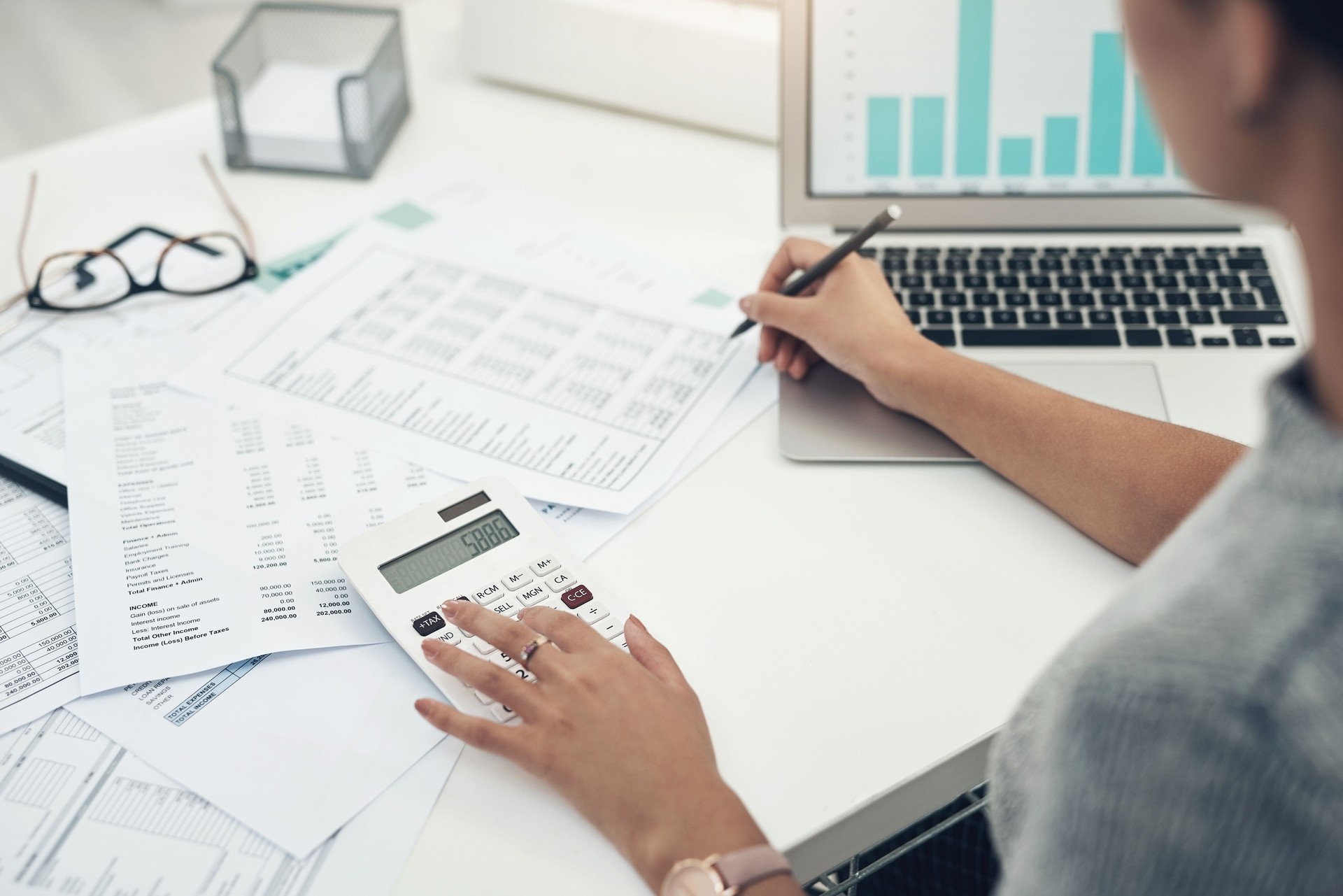 Closeup shot of an unrecognisable businesswoman calculating finances in an office